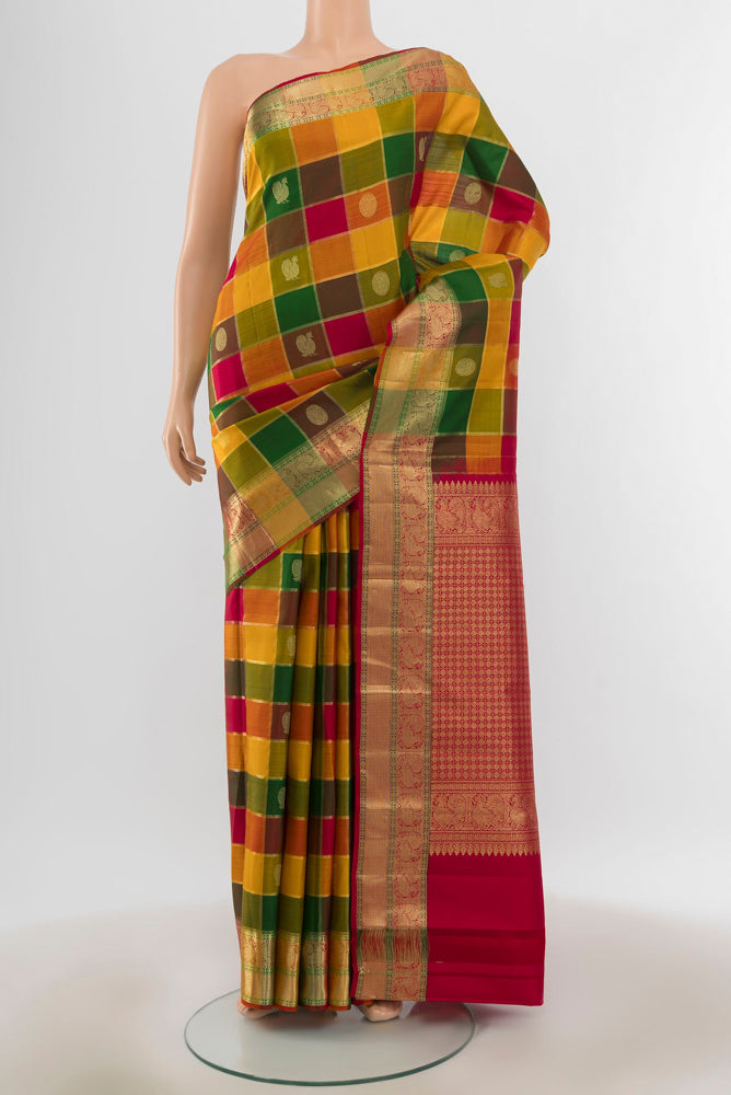 Pure Silk Pure Zari Multi Color Kanjivaram Saree with Zari Butta on the body and Silk Border.  displayed on a mannequin