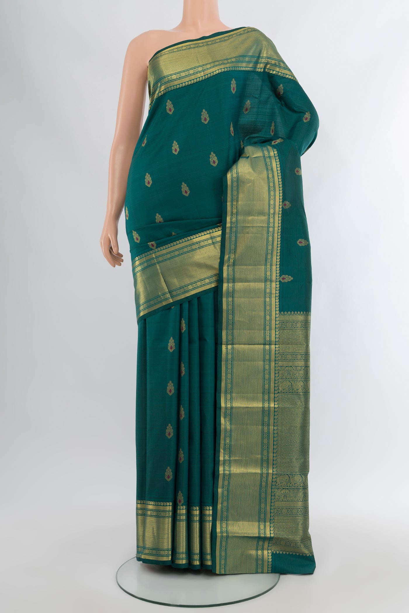 Peacock Blue Kanjivaram Silk Saree with Zari Butta on the body and Zari Border.  displayed on a mannequin