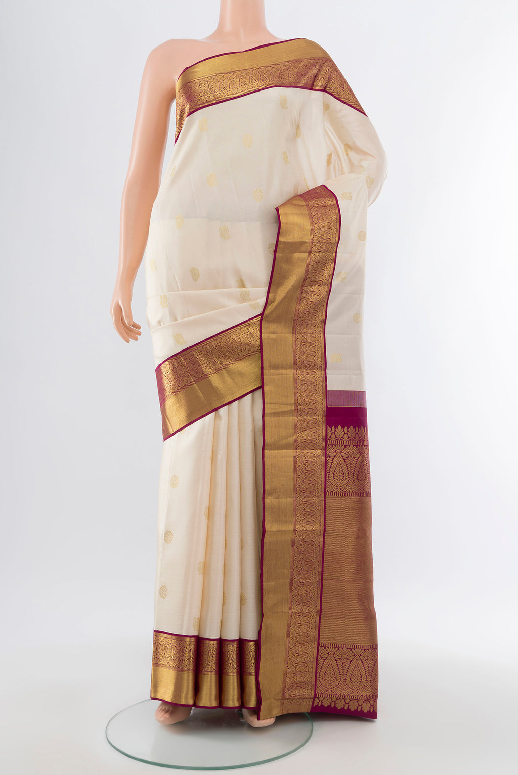 Pure Silk Pure Zari Cream Kanjivaram Saree with Zari Butta on the body and Silk Border.  displayed on a mannequin