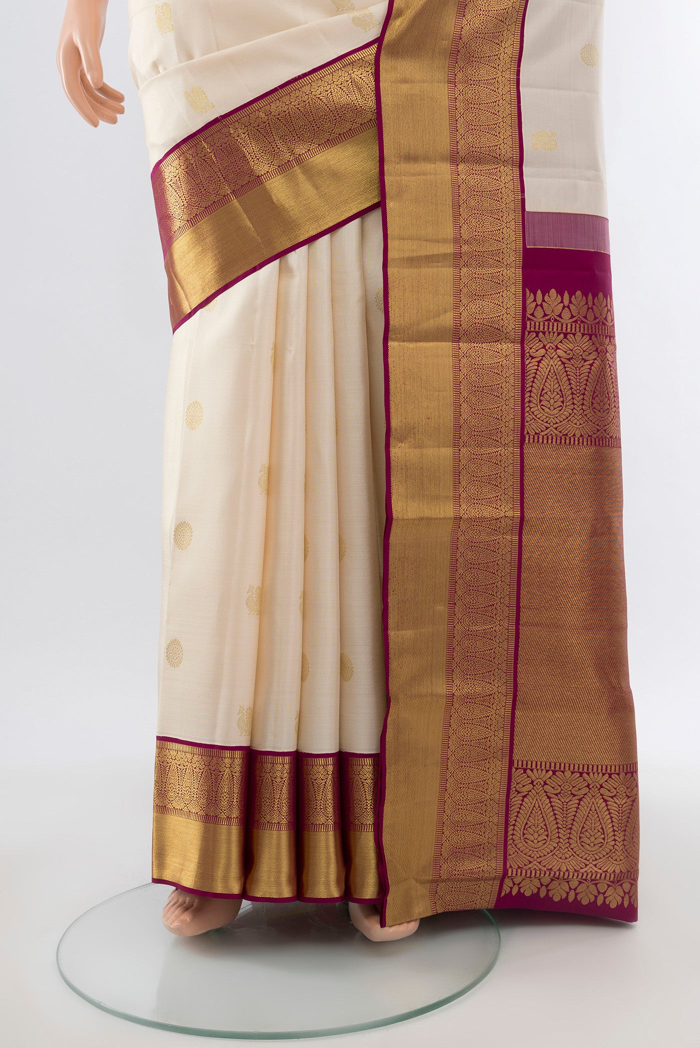 Pleats and pallu of Pure Silk Pure Zari Cream Kanjivaram Saree with Zari Butta on the body and Silk Border. 