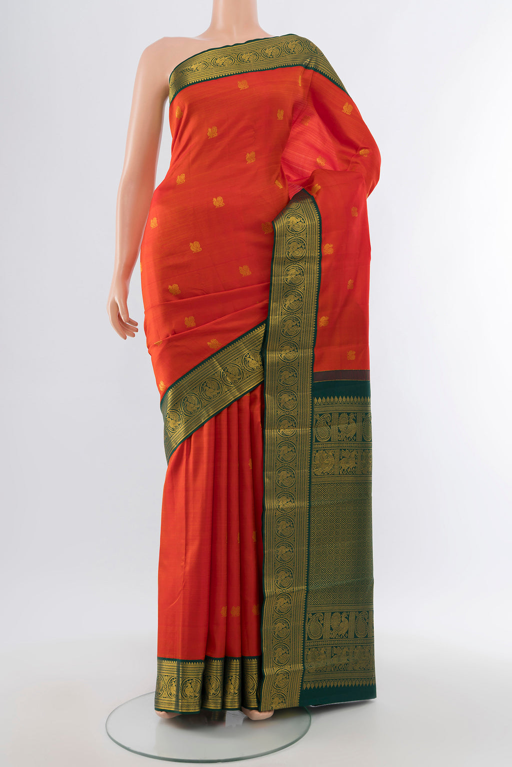 Pure Silk Pure Zari Red Kanjivaram Saree with Zari Butta on the body and Silk Border.  displayed on a mannequin
