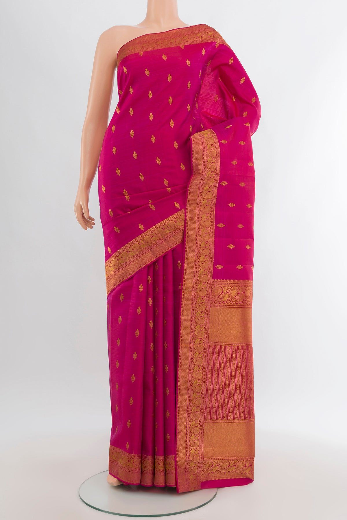 Dark Pink Kanjivaram Silk Saree with Zari Butta on the body and Zari Border.  displayed on a mannequin