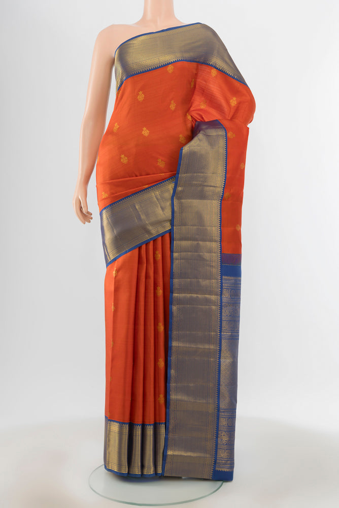 Pure Silk Pure Zari Peach Kanjivaram Saree with Zari Butta on the body and Silk Border.  displayed on a mannequin