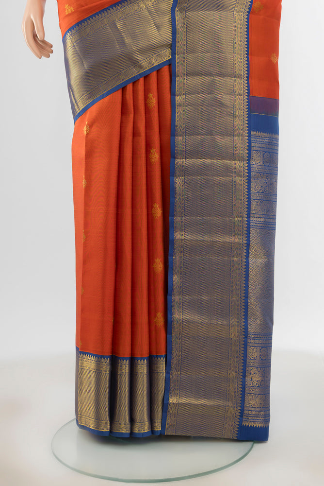 Pleats and pallu of Pure Silk Pure Zari Peach Kanjivaram Saree with Zari Butta on the body and Silk Border. 
