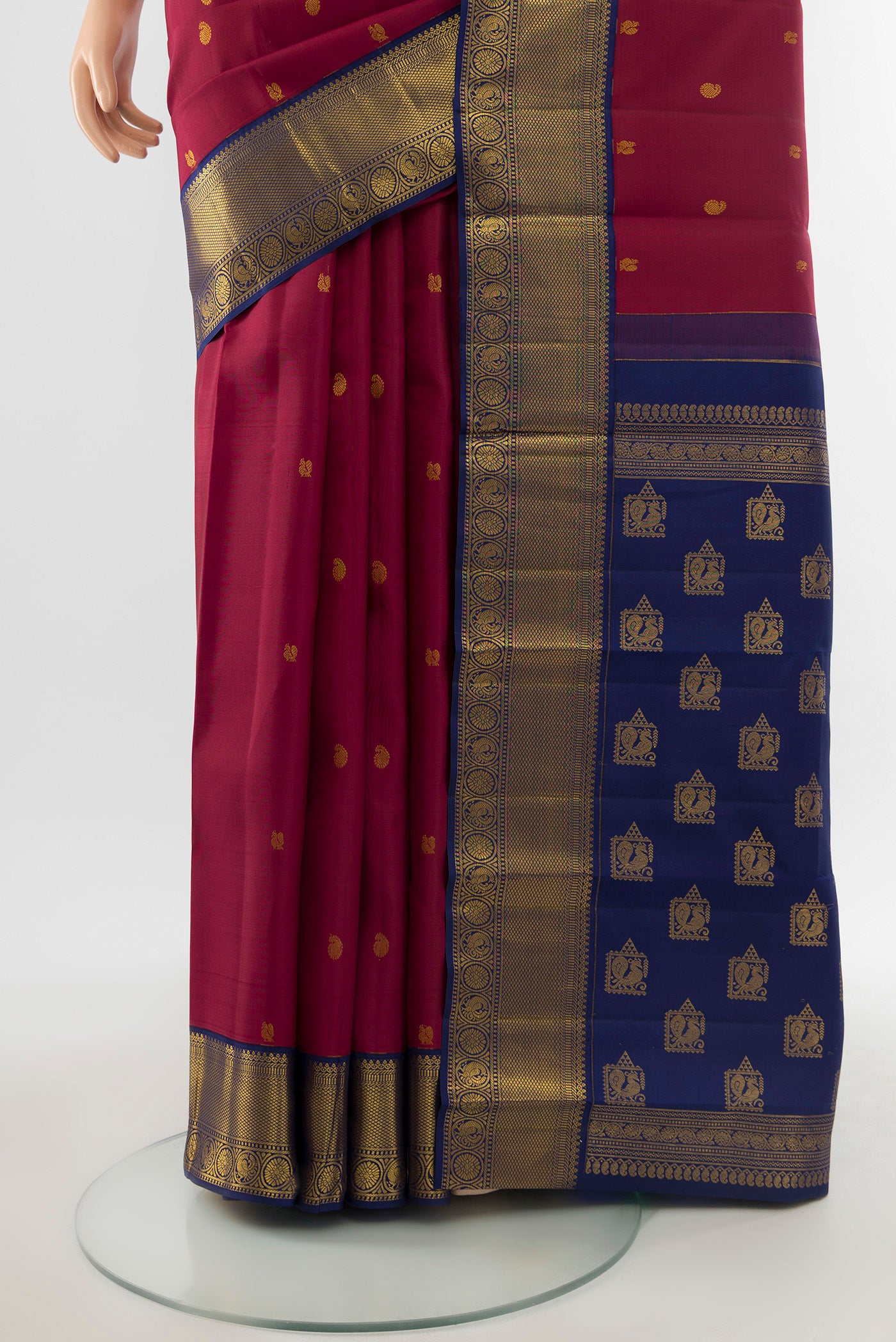 Pleats and pallu of Pure Silk Pure Zari Maroon Kanjivaram Saree with Zari Butta on the body and Silk Border. 