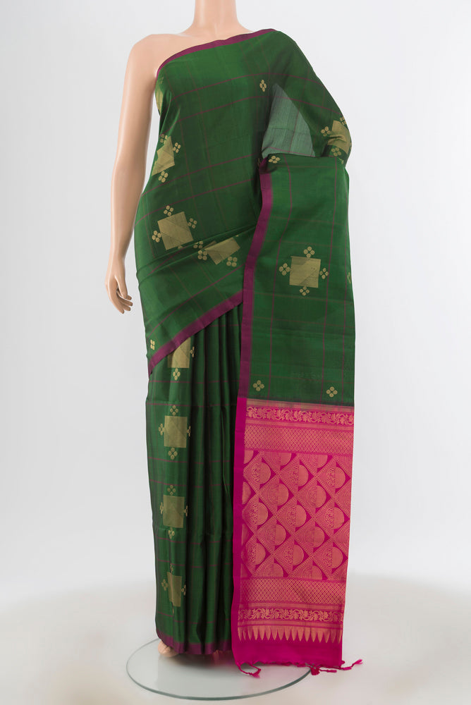 Bottle Green Soft Silk Saree with Zari Brocade on the body and Silk Border.  displayed on a mannequin