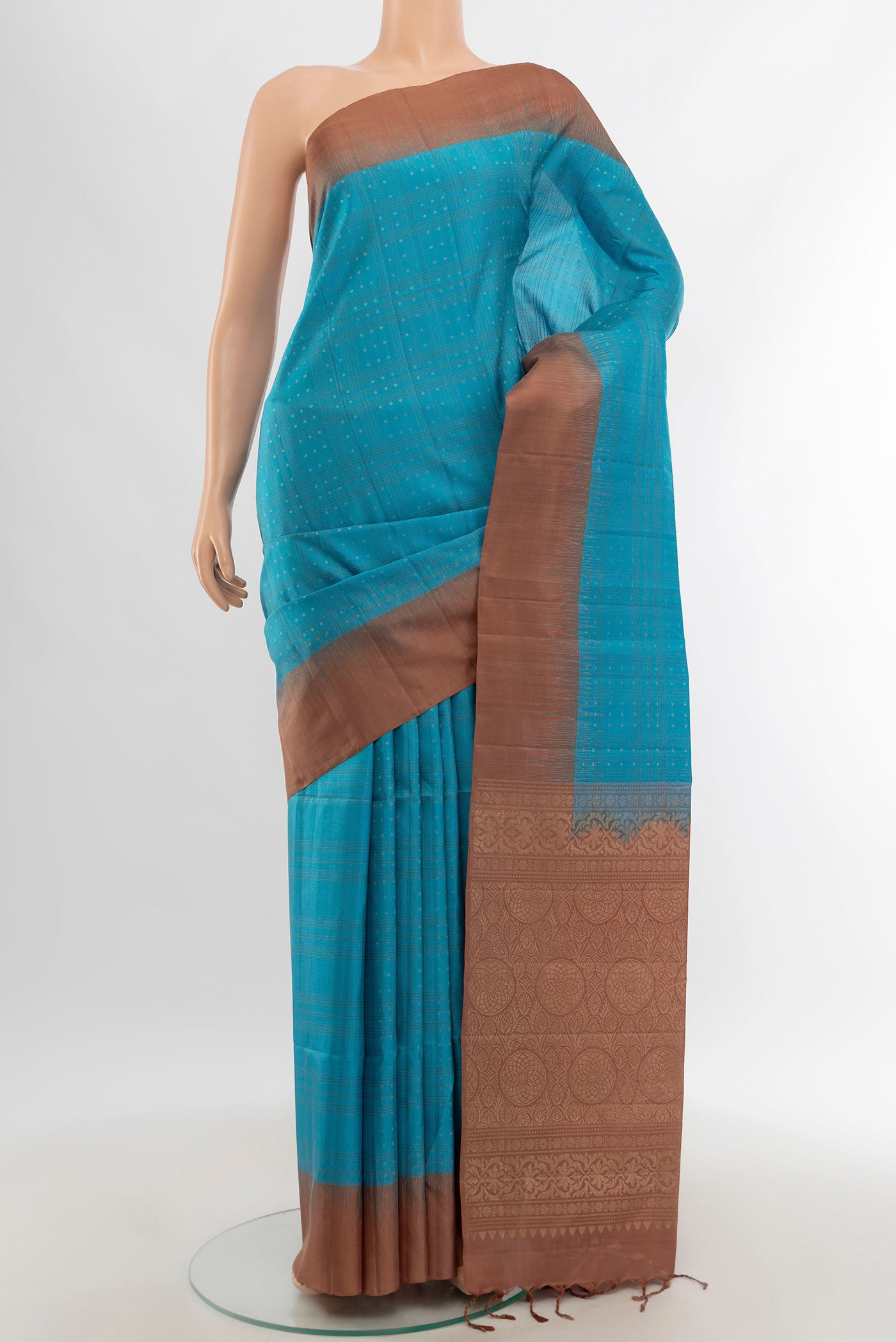 Light Blue Soft Silk Saree with Zari Butta on the body and Plain Border.  displayed on a mannequin