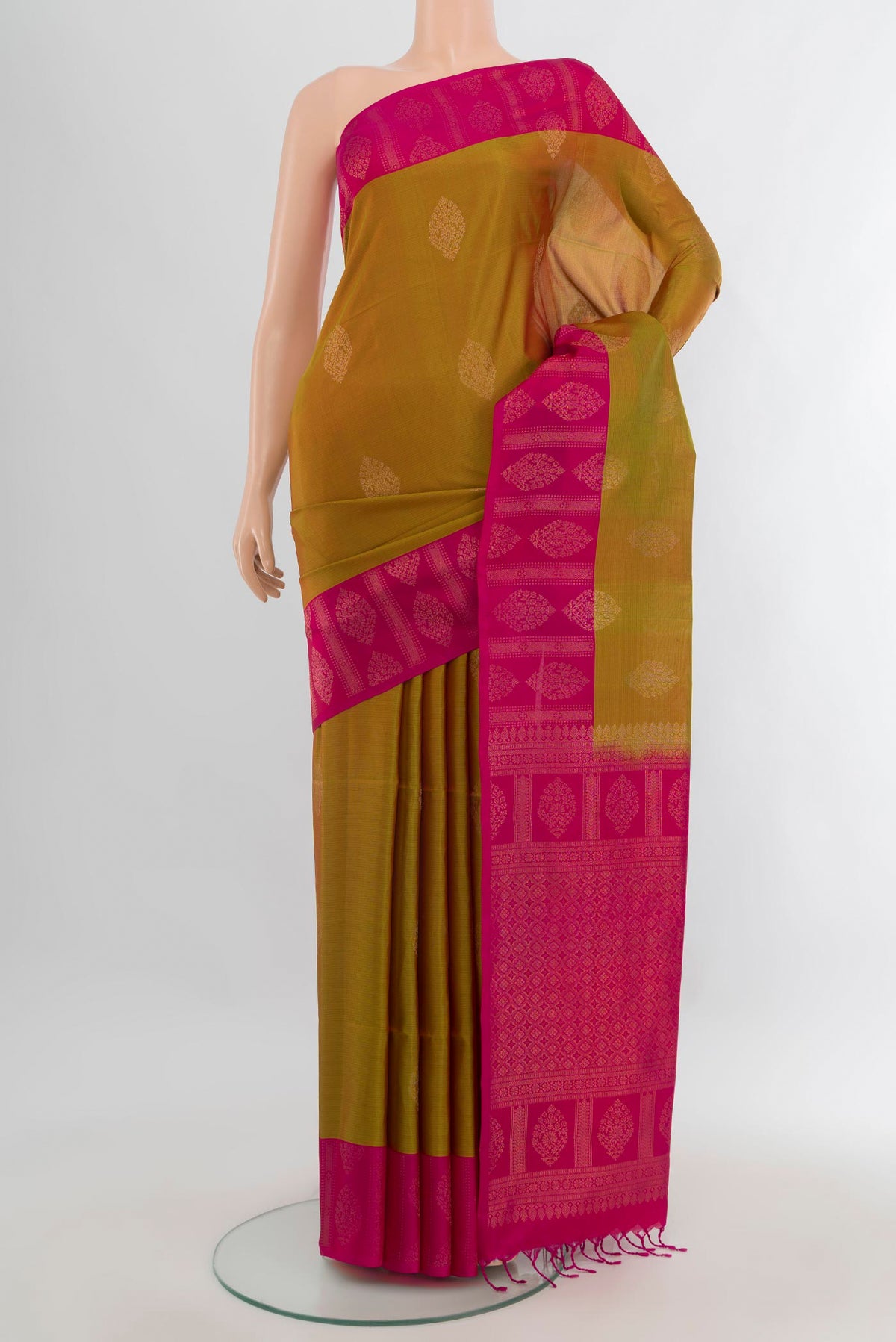 Pure Silk Mehandi Green Dual Tone Soft Saree with Zari Butta on the body and Fancy Border.  displayed on a mannequin