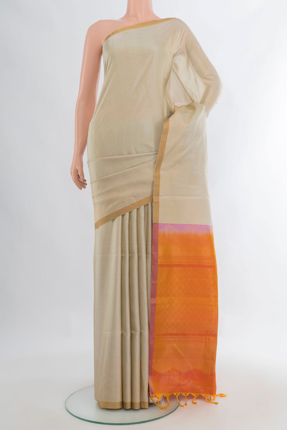 Pure Silk Beige Soft Saree with Zari Butta on the body and Zari Border.  displayed on a mannequin