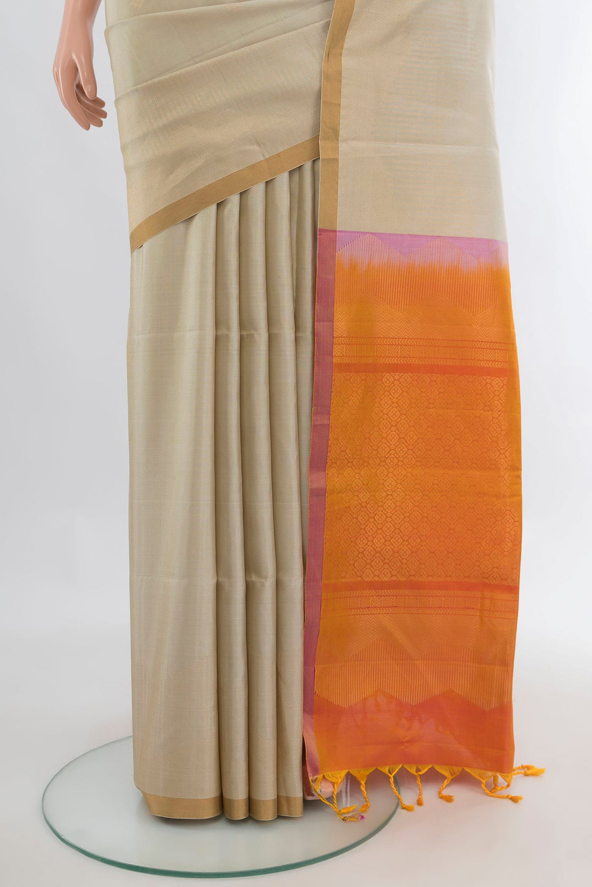 Pleats and pallu of Pure Silk Beige Soft Saree with Zari Butta on the body and Zari Border. 