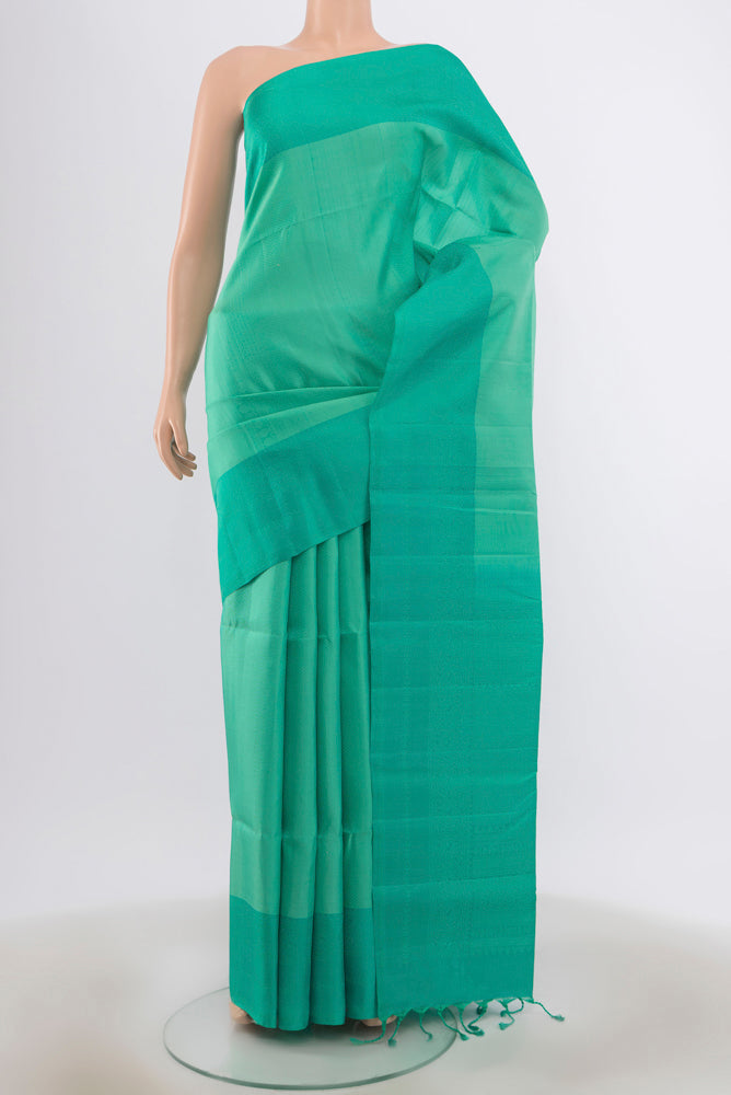 Sky Blue Soft Silk Saree with Zari Butta on the body and Silk Border.  displayed on a mannequin