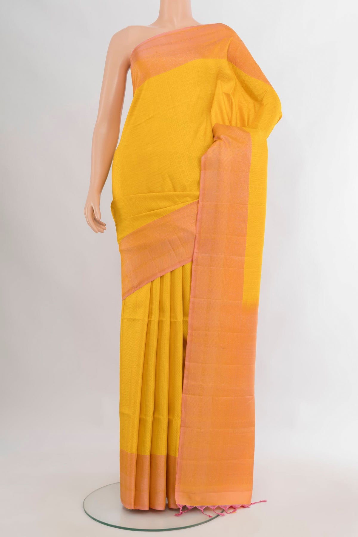 Pure Silk Yellow Soft Saree with Zari Butta on the body and Plain Border.  displayed on a mannequin