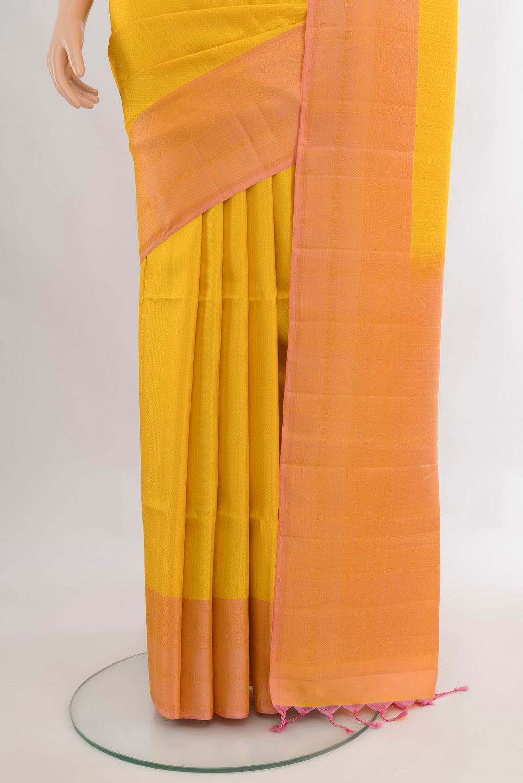 Pleats and pallu of Pure Silk Yellow Soft Saree with Zari Butta on the body and Plain Border. 