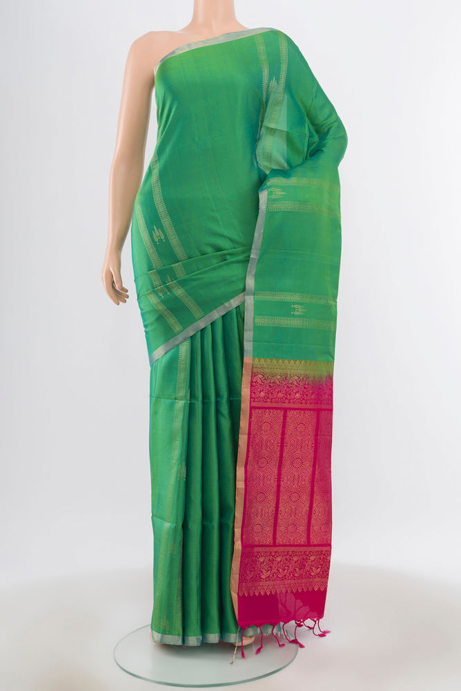 Pure Silk Pure Zari Light Green Soft Saree with Zari Butta on the body and Silk Border.  displayed on a mannequin