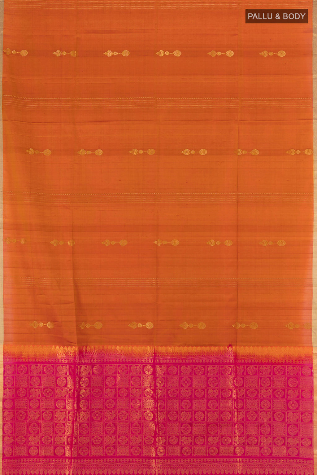 Flat view of Rust Soft Silk Saree with Zari Butta on the body and Zari Border. 