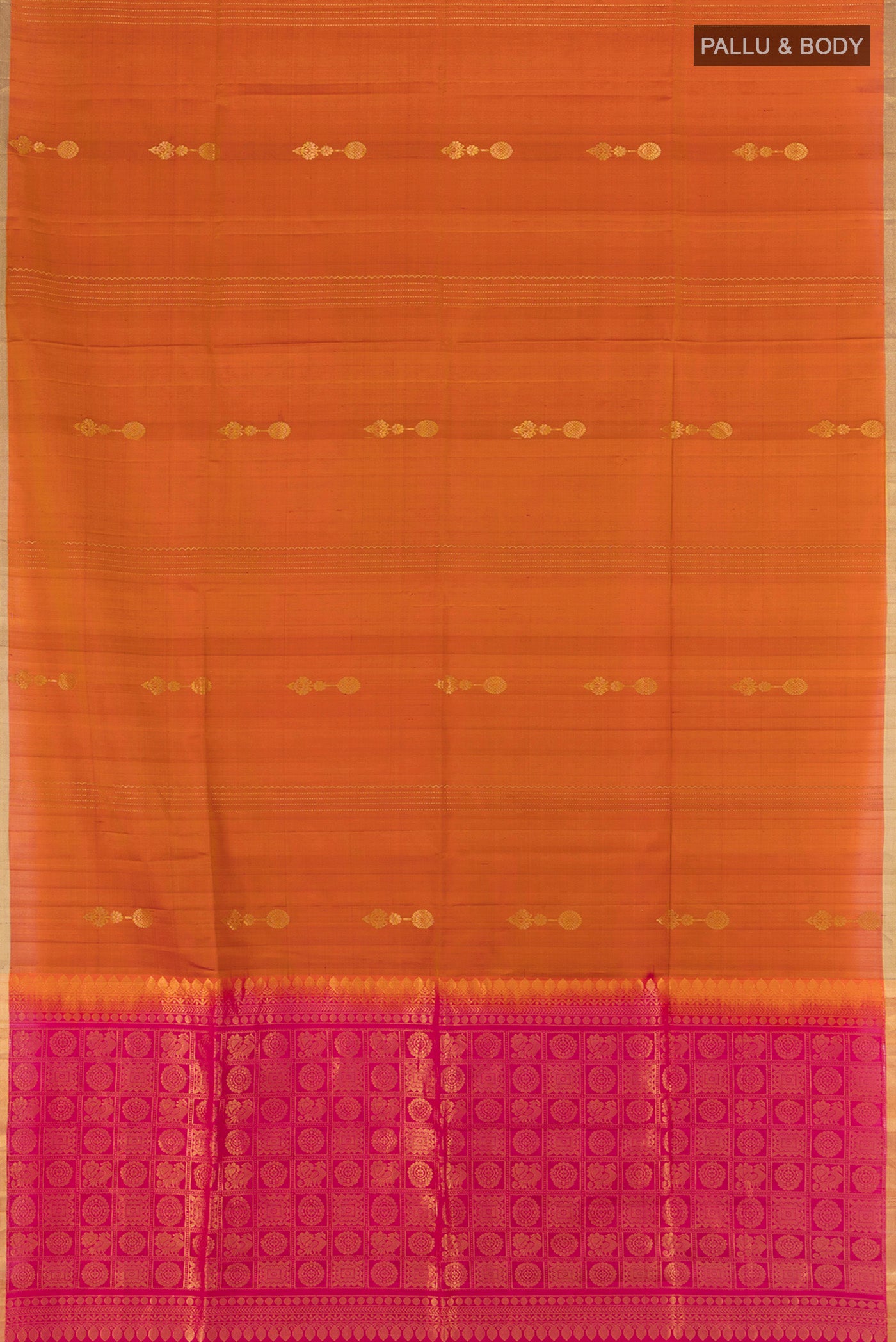 Flat view of Rust Soft Silk Saree with Zari Butta on the body and Zari Border. 