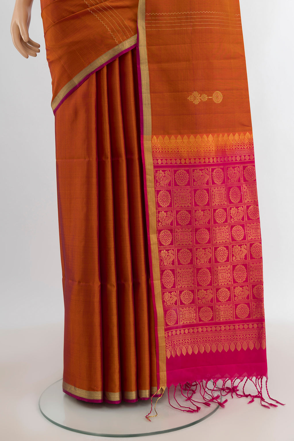 Pleats and pallu of Rust Soft Silk Saree with Zari Butta on the body and Zari Border. 
