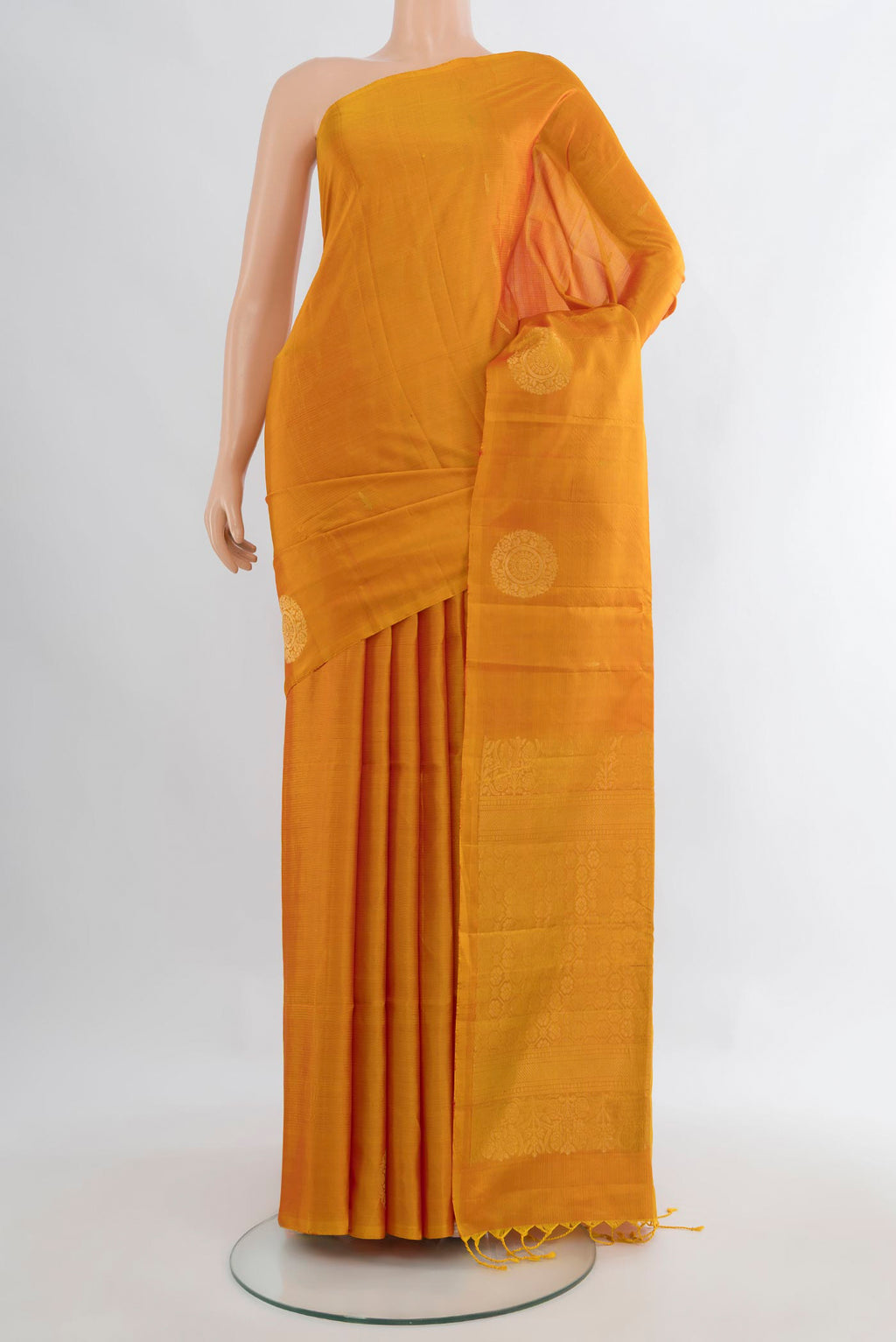 Pure Silk Mustard Soft Saree with Zari Butta on the body and Without Border.  displayed on a mannequin