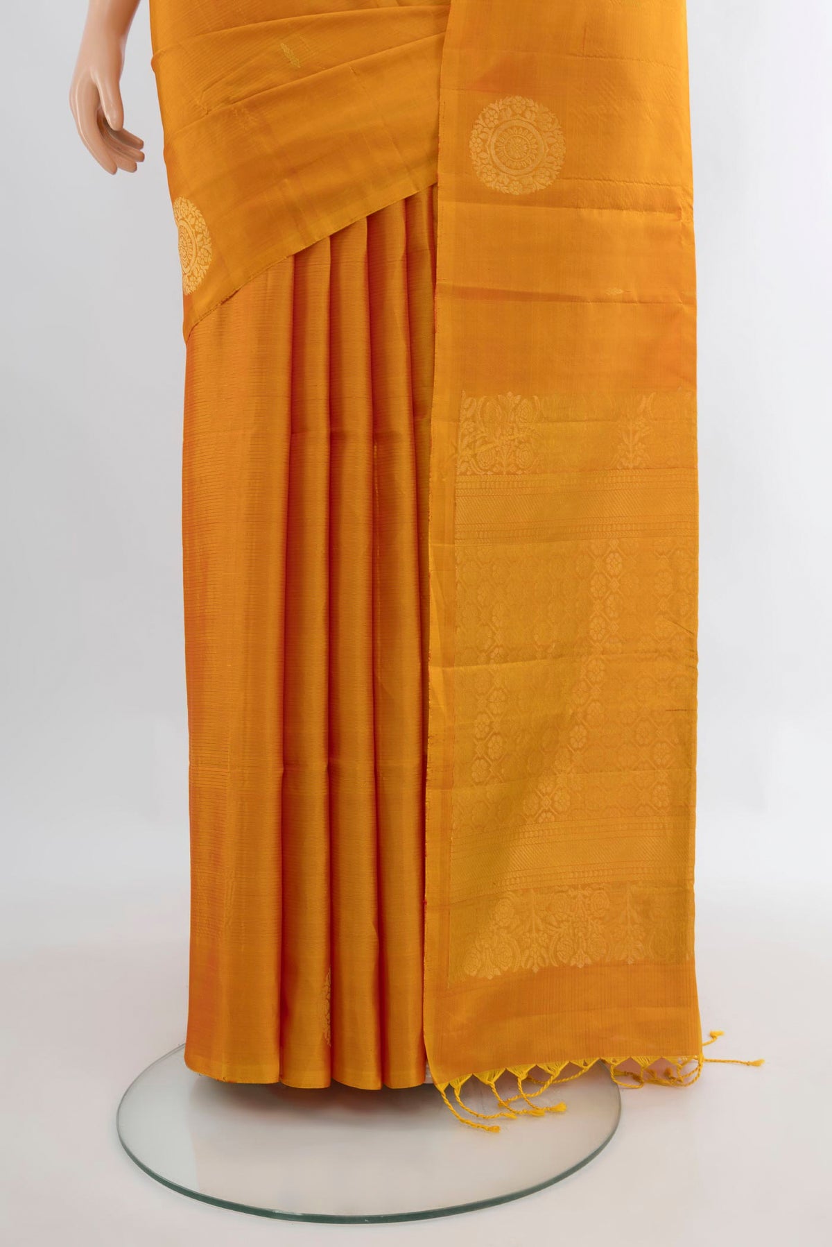 Pleats and pallu of Pure Silk Mustard Soft Saree with Zari Butta on the body and Without Border. 
