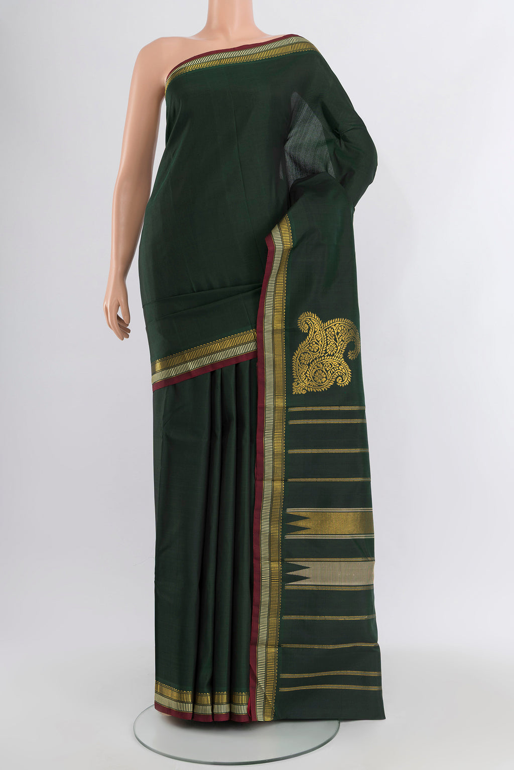 Bottle Green Kanchipuram Silk Saree with Plain Body and Zari Border.  displayed on a mannequin