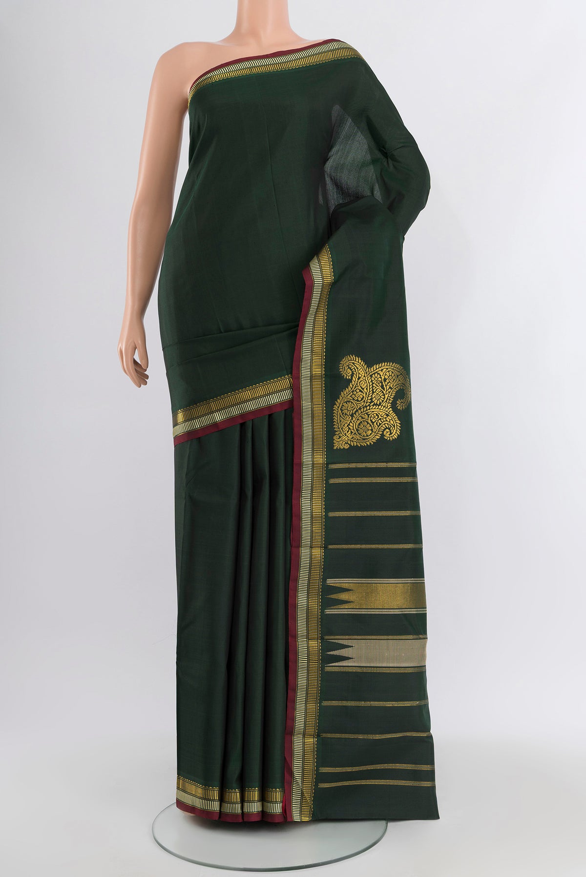 Bottle Green Kanchipuram Silk Saree with Plain Body and Zari Border.  displayed on a mannequin