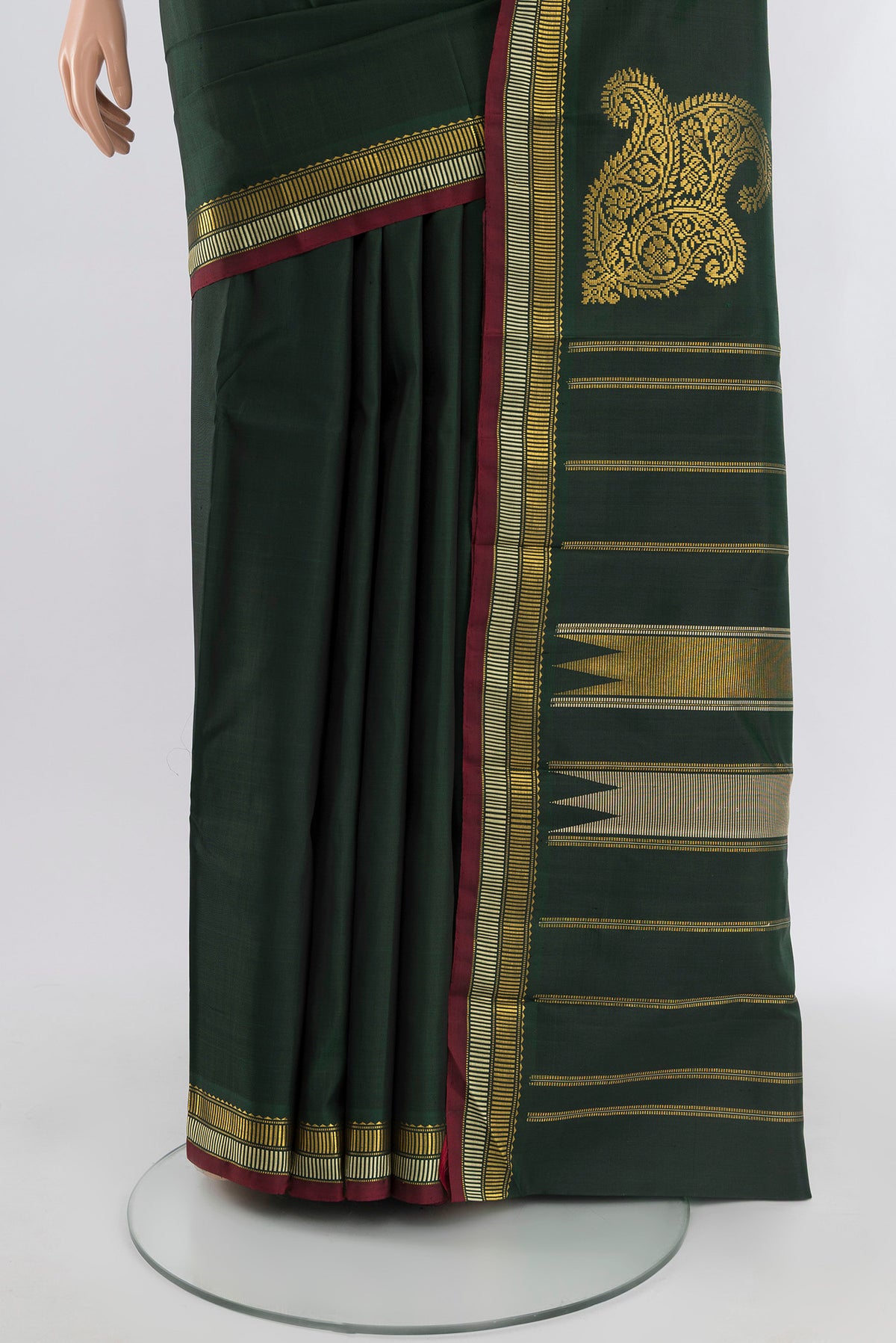 Pleats and pallu of Bottle Green Kanchipuram Silk Saree with Plain Body and Zari Border. 