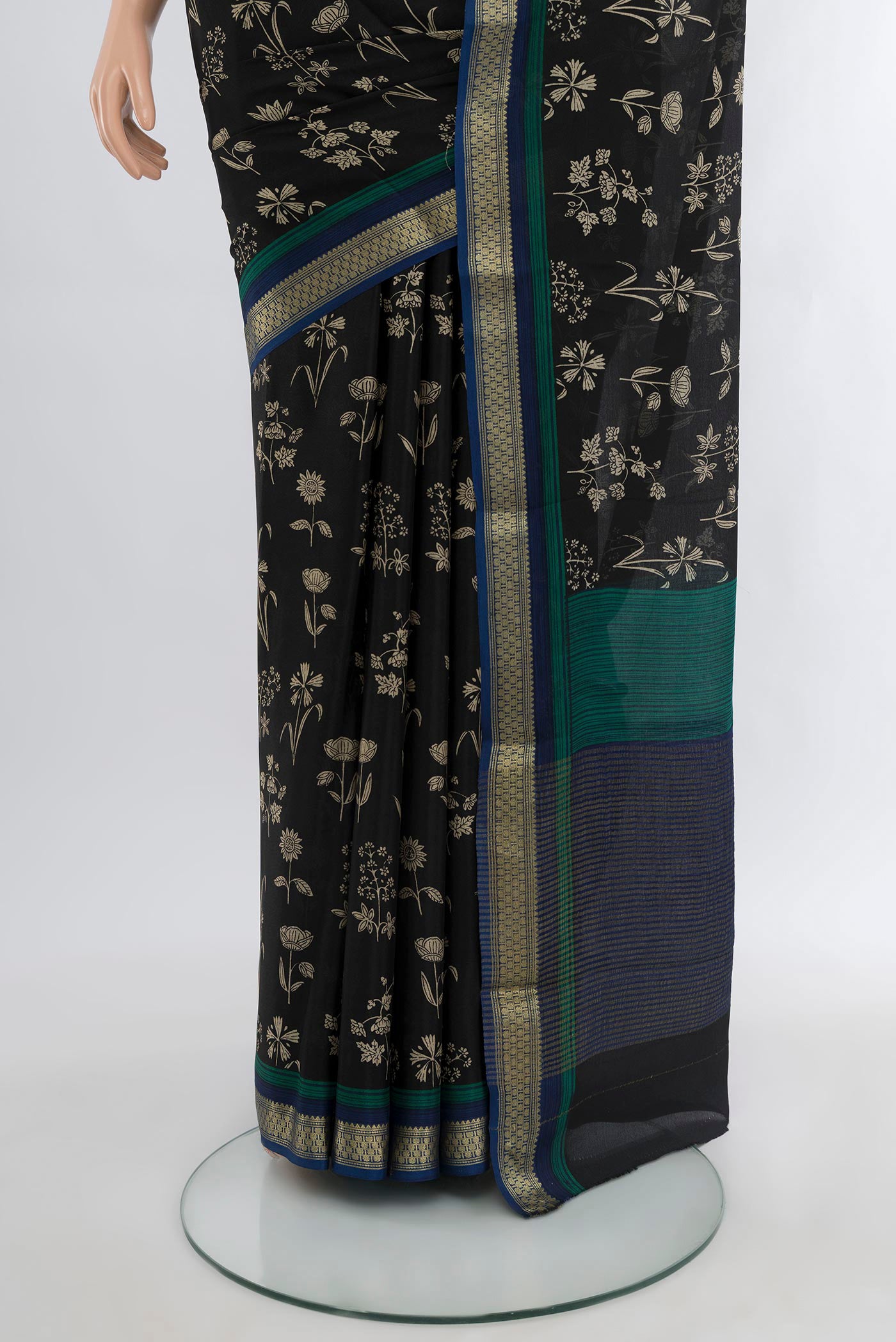 Pleats and pallu of Black Mysore Crepe Saree with Floral Print on the body and Zari Border. 