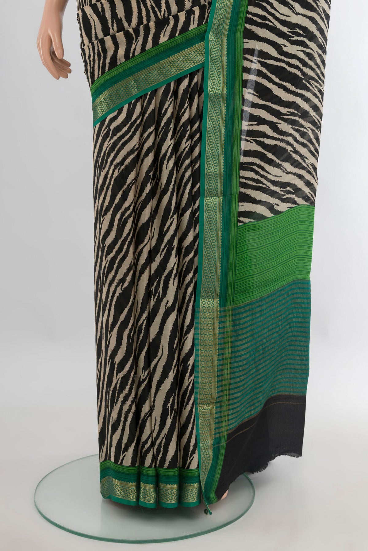 Pleats and pallu of Black Crepe Saree with Printed design on the body and Zari Border. 