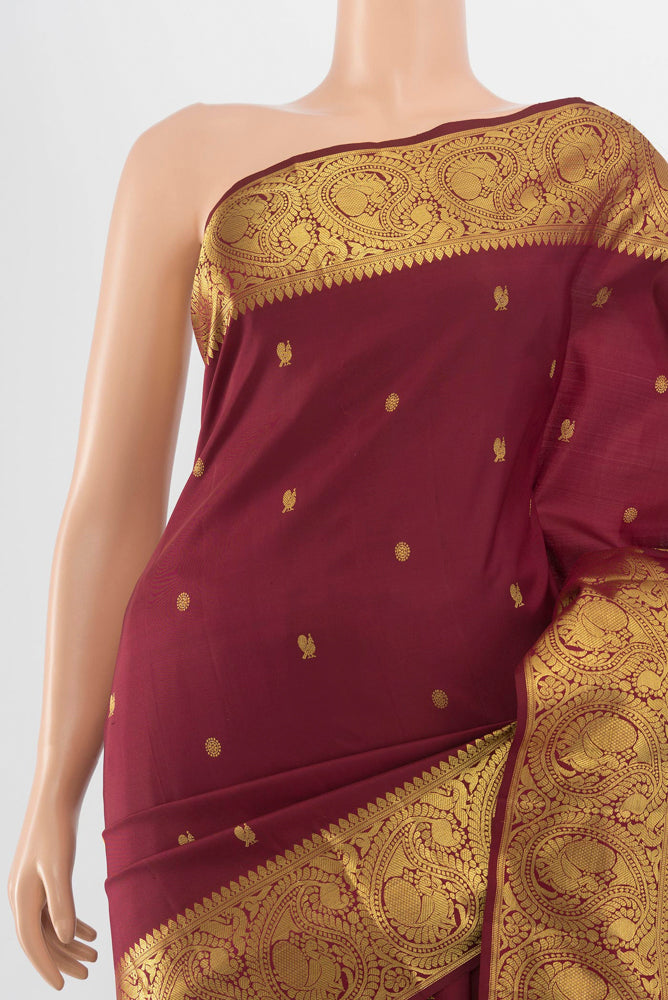 Border image of Maroon Kanchipuram Silk Saree with Zari Butta on the body and Silk Border. 