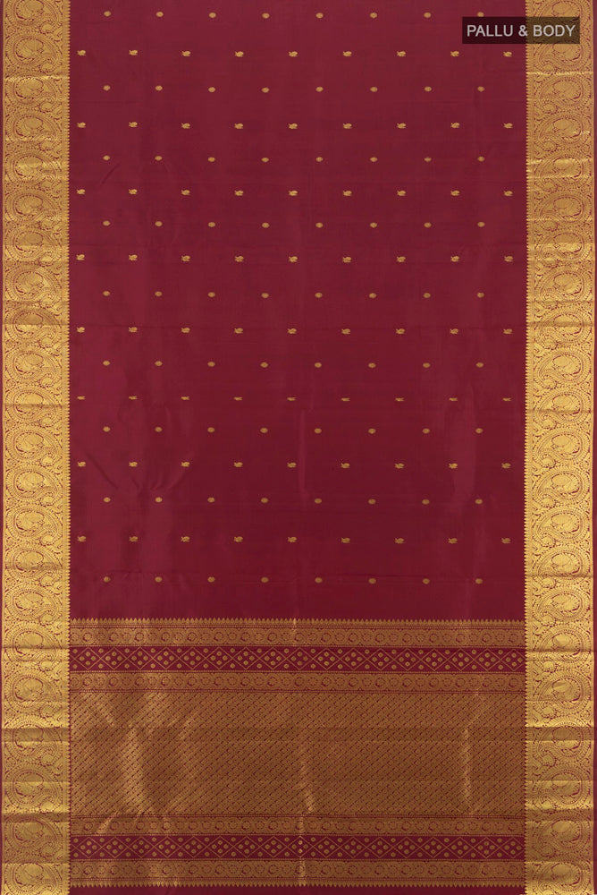 Flat view of Maroon Kanchipuram Silk Saree with Zari Butta on the body and Silk Border. 