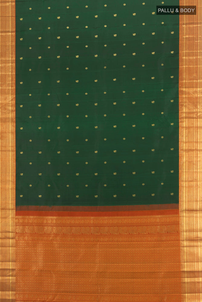 Flat view of Bottle Green Kanchipuram Silk Saree with Zari Butta on the body and Silk Border. 