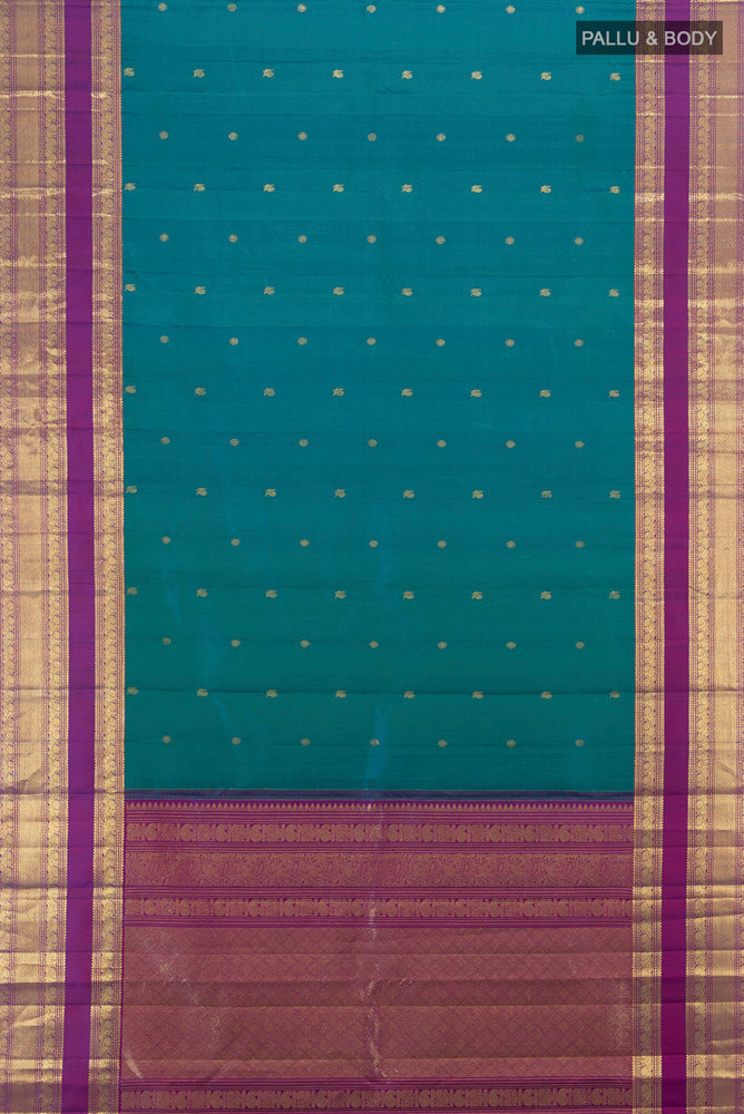 Flat view of Peacock Blue Kanchipuram Silk Saree with Zari Butta on the body and Silk Border. 