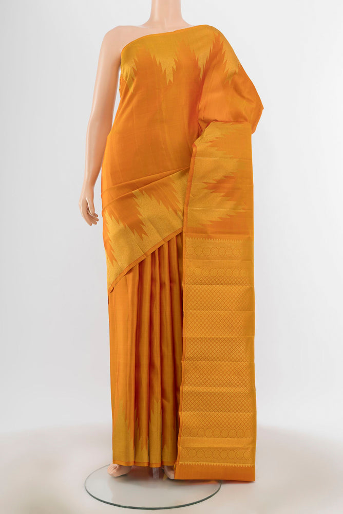 Mustard Kanjivaram Silk Saree with Zari Butta on the body and Silk Border.  displayed on a mannequin