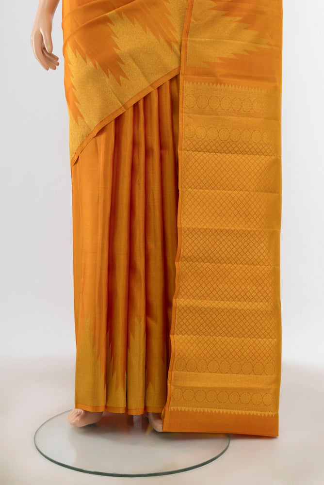 Pleats and pallu of Mustard Kanjivaram Silk Saree with Zari Butta on the body and Silk Border. 