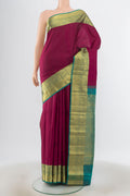 Purple Kanjivaram Silk Saree with Zari Butta on the body and Silk Border.  displayed on a mannequin