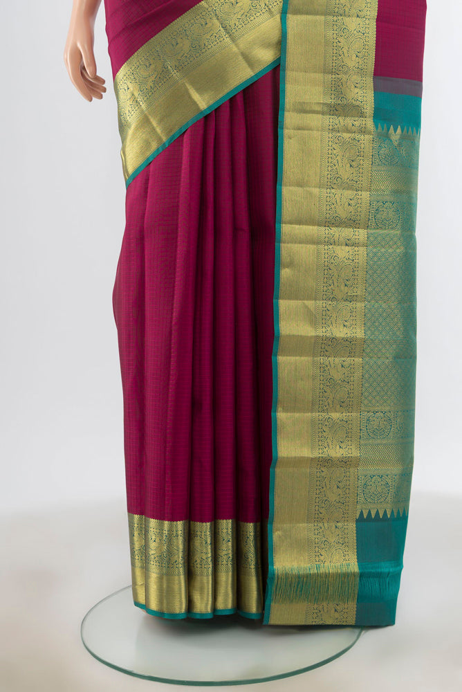 Pleats and pallu of Purple Kanjivaram Silk Saree with Zari Butta on the body and Silk Border. 
