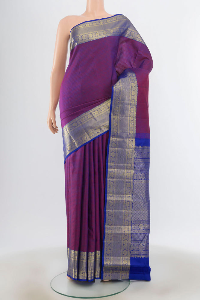 Purple Kanjivaram Silk Saree with Zari Butta on the body and Silk Border.  displayed on a mannequin