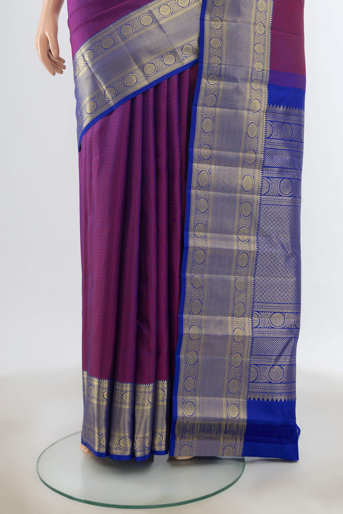 Pleats and pallu of Purple Kanjivaram Silk Saree with Zari Butta on the body and Silk Border. 