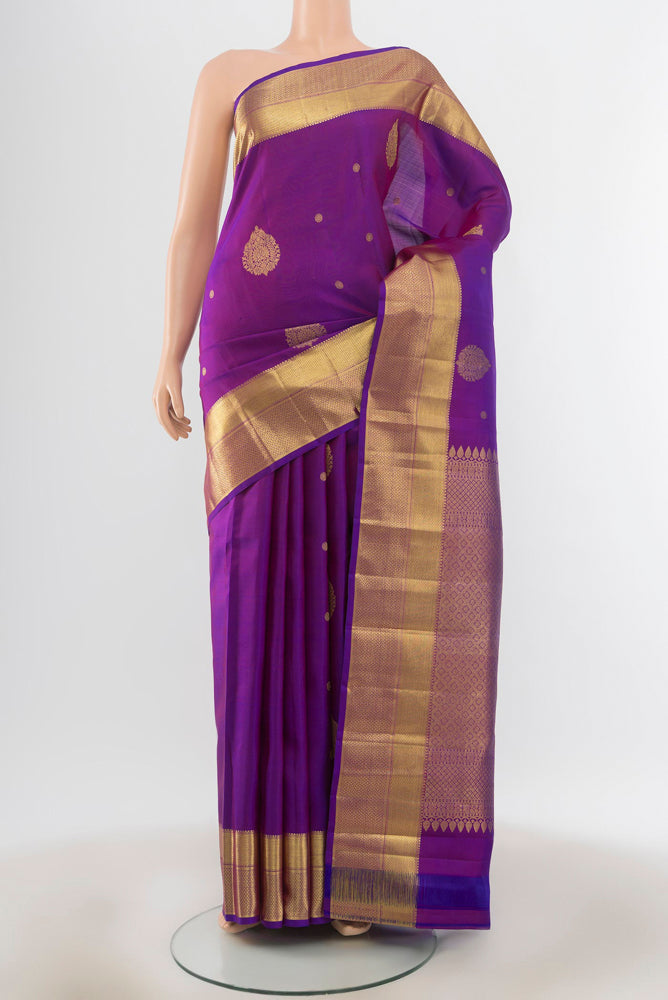 Violet Kanjivaram Silk Saree with Zari Butta on the body and Silk Border.  displayed on a mannequin