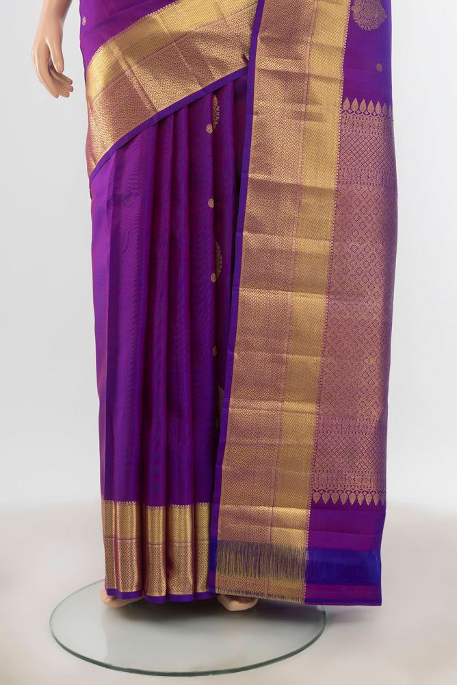 Pleats and pallu of Violet Kanjivaram Silk Saree with Zari Butta on the body and Silk Border. 