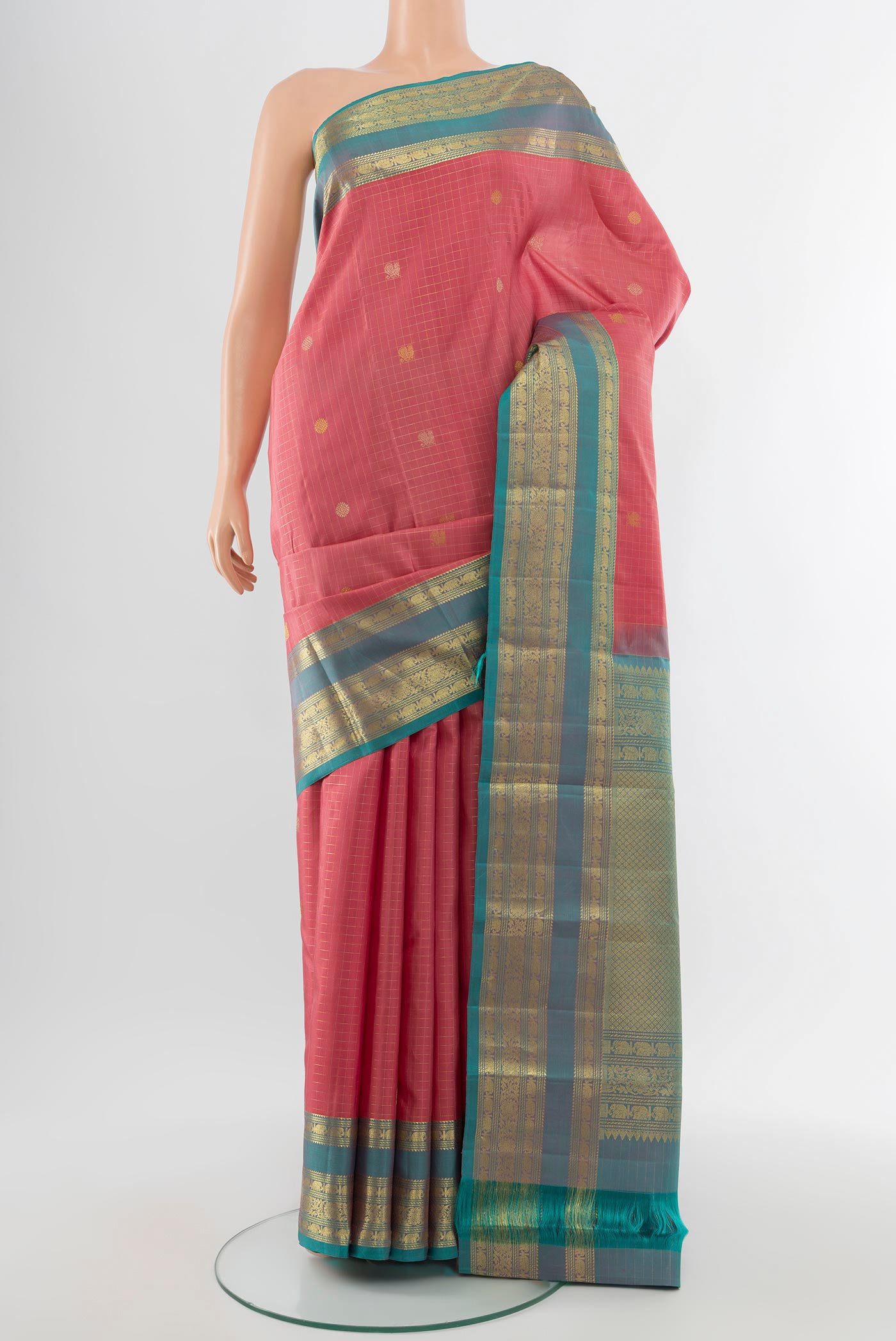 Pure Silk Pure Zari Rose Gold Kanjivaram Saree with Zari Butta on the body and Silk Border.  displayed on a mannequin