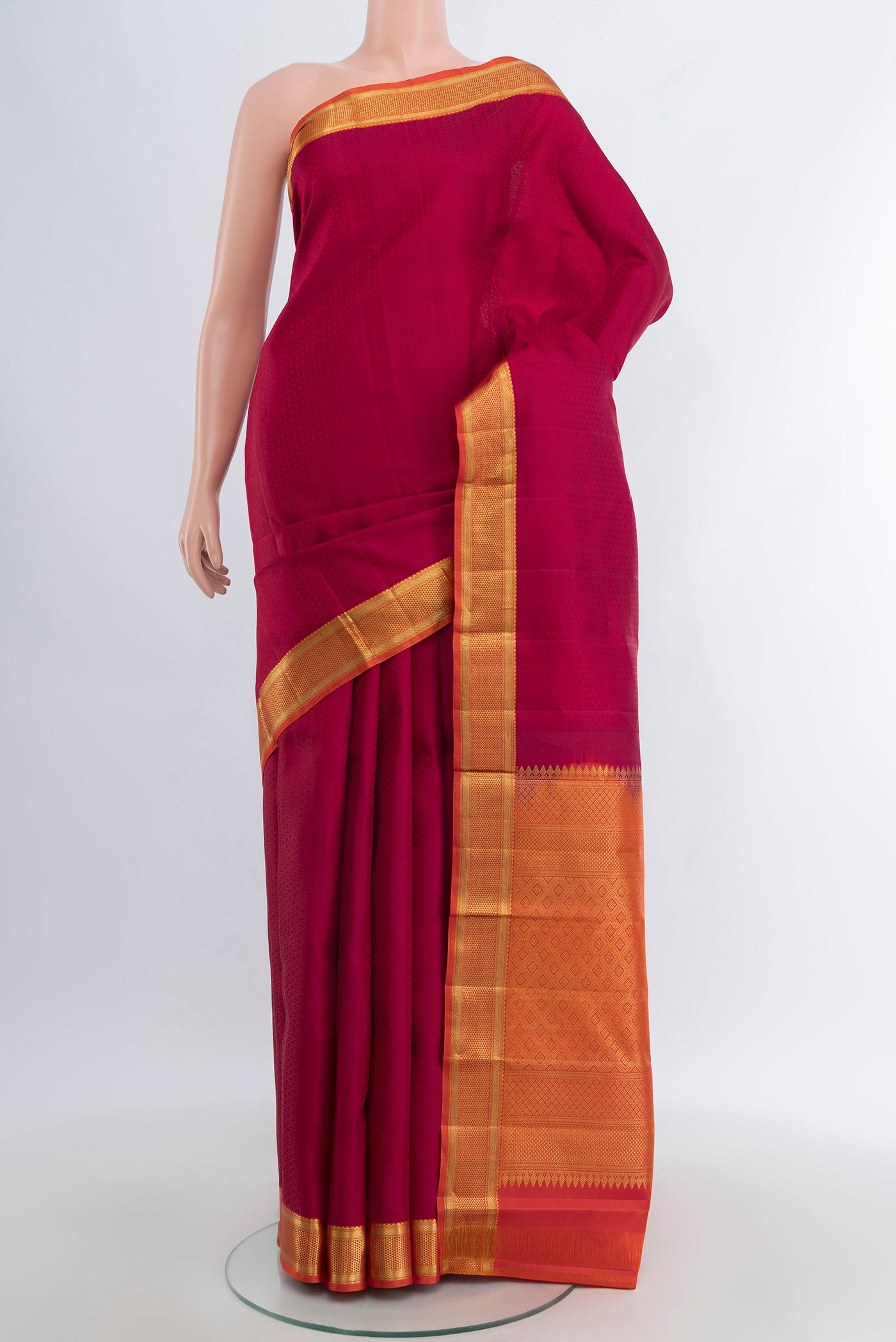 Maroon Kanjivaram Silk Saree with Jacquard design on the body and Zari Border.  displayed on a mannequin