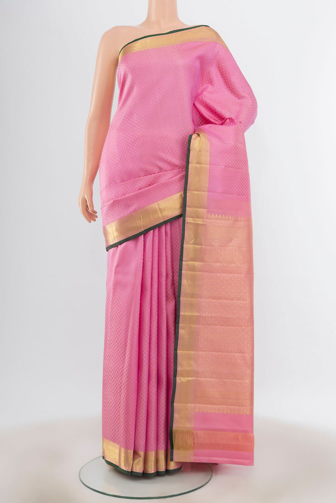 Rose pink Kanjivaram Silk Saree with Zari Butta on the body and Silk Border.  displayed on a mannequin