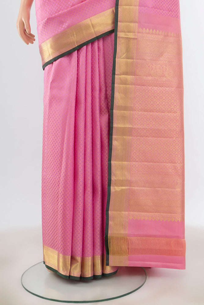 Pleats and pallu of Rose pink Kanjivaram Silk Saree with Zari Butta on the body and Silk Border. 
