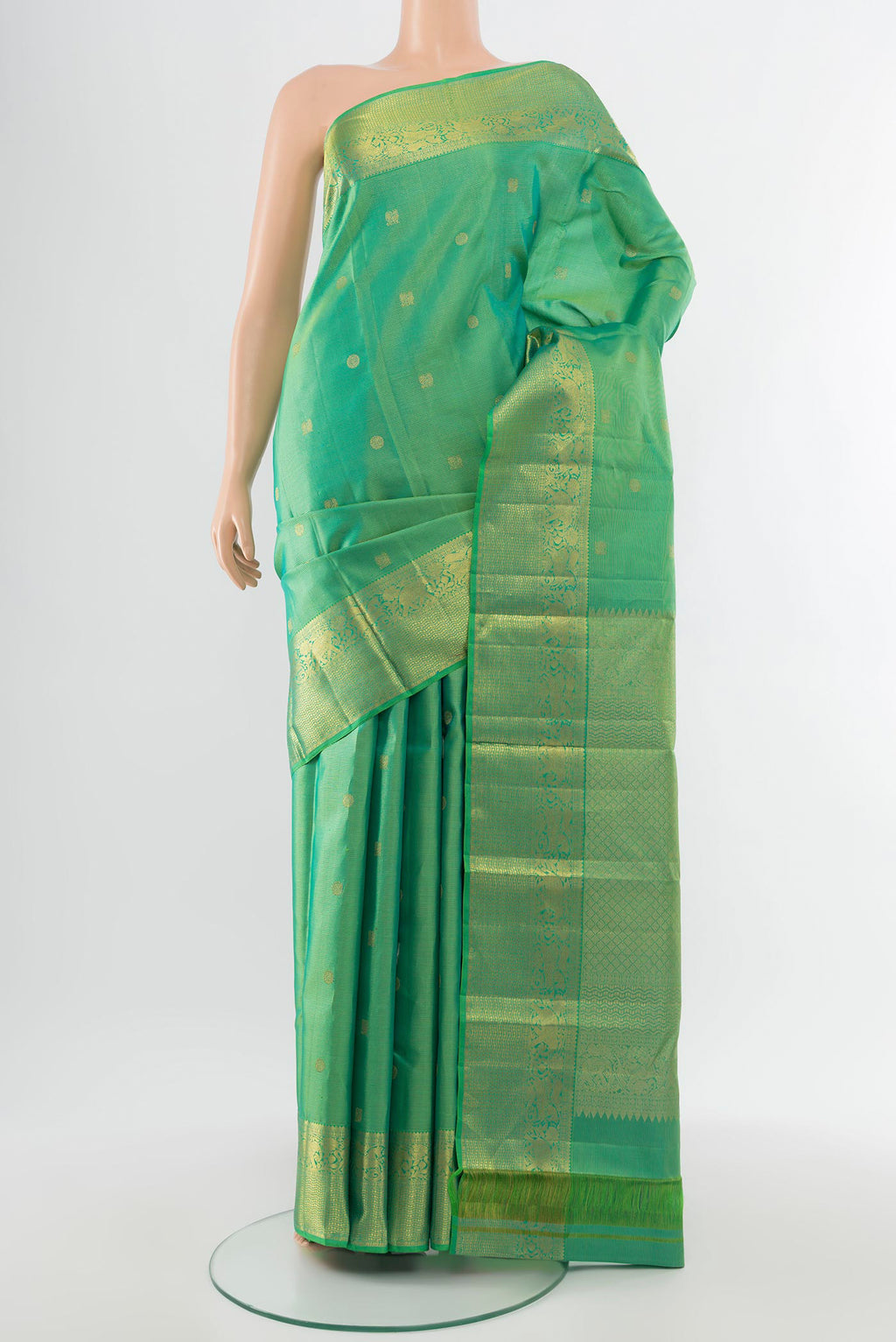 Pure Silk Pure Zari Parrot Green Kanjivaram Saree with Zari Butta on the body and Silk Border.  displayed on a mannequin