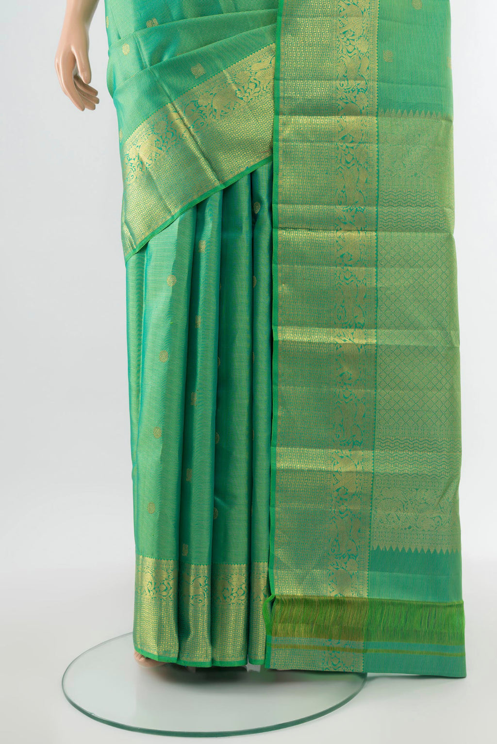 Pleats and pallu of Pure Silk Pure Zari Parrot Green Kanjivaram Saree with Zari Butta on the body and Silk Border. 