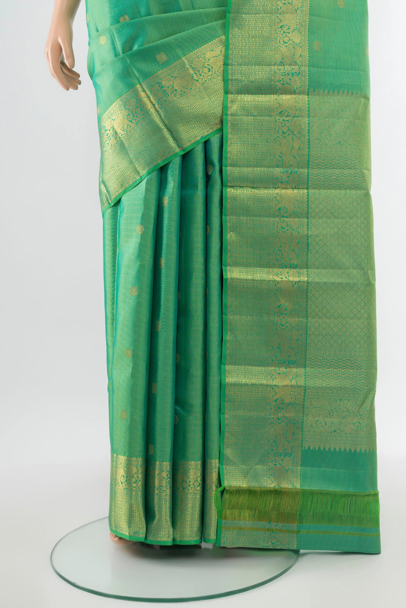 Pleats and pallu of Pure Silk Pure Zari Parrot Green Kanjivaram Saree with Zari Butta on the body and Silk Border. 