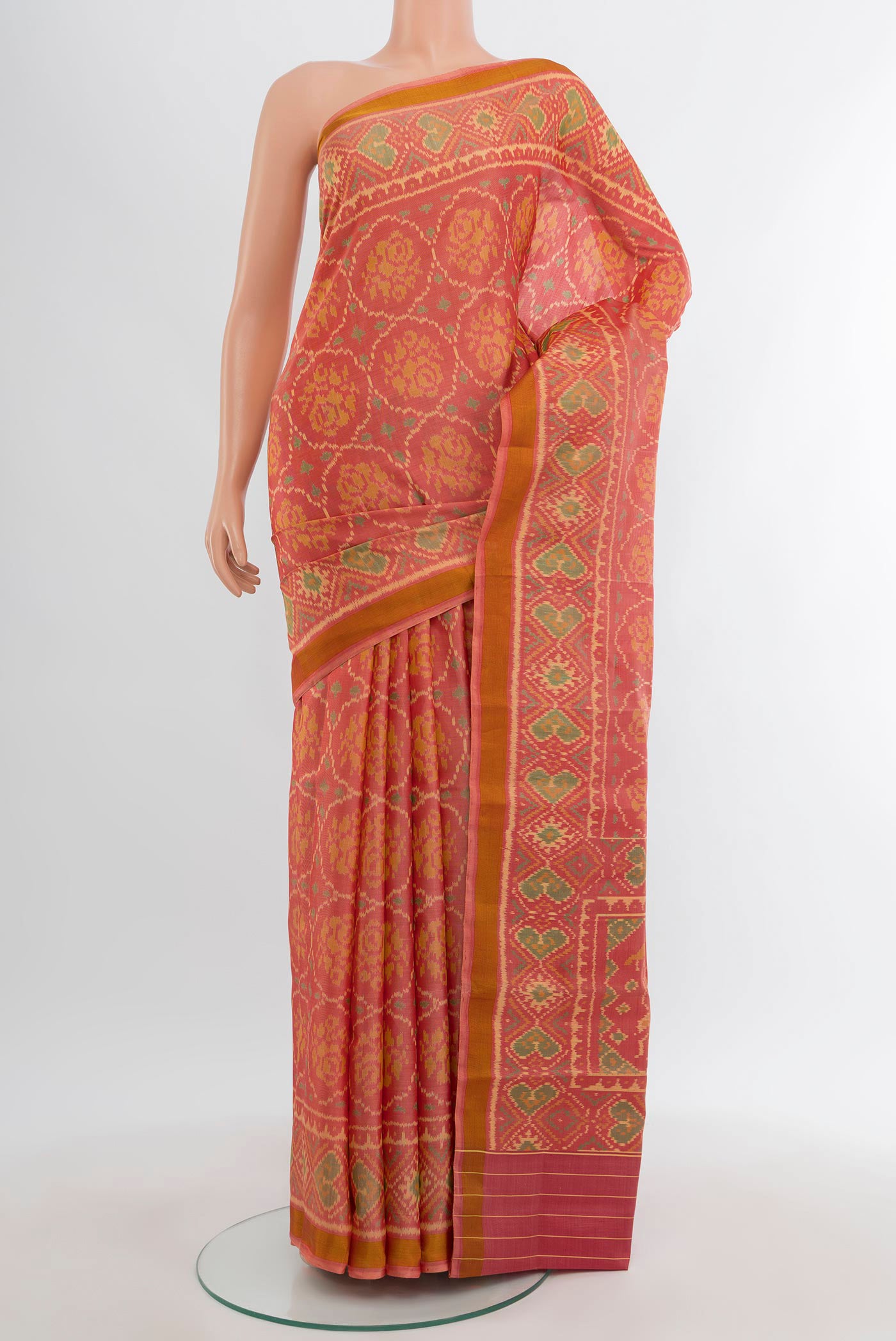 Orange Rajkot Patola Silk Saree with Pure Ikat on the body and Ikat Border.  displayed on a mannequin