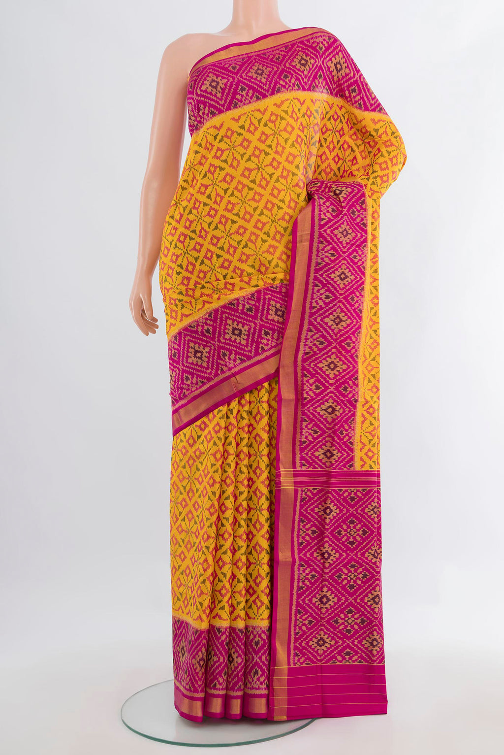 Pure Silk Yellow Rajkot Patola Saree with Pure Ikat on the body and Ikat Border.  displayed on a mannequin