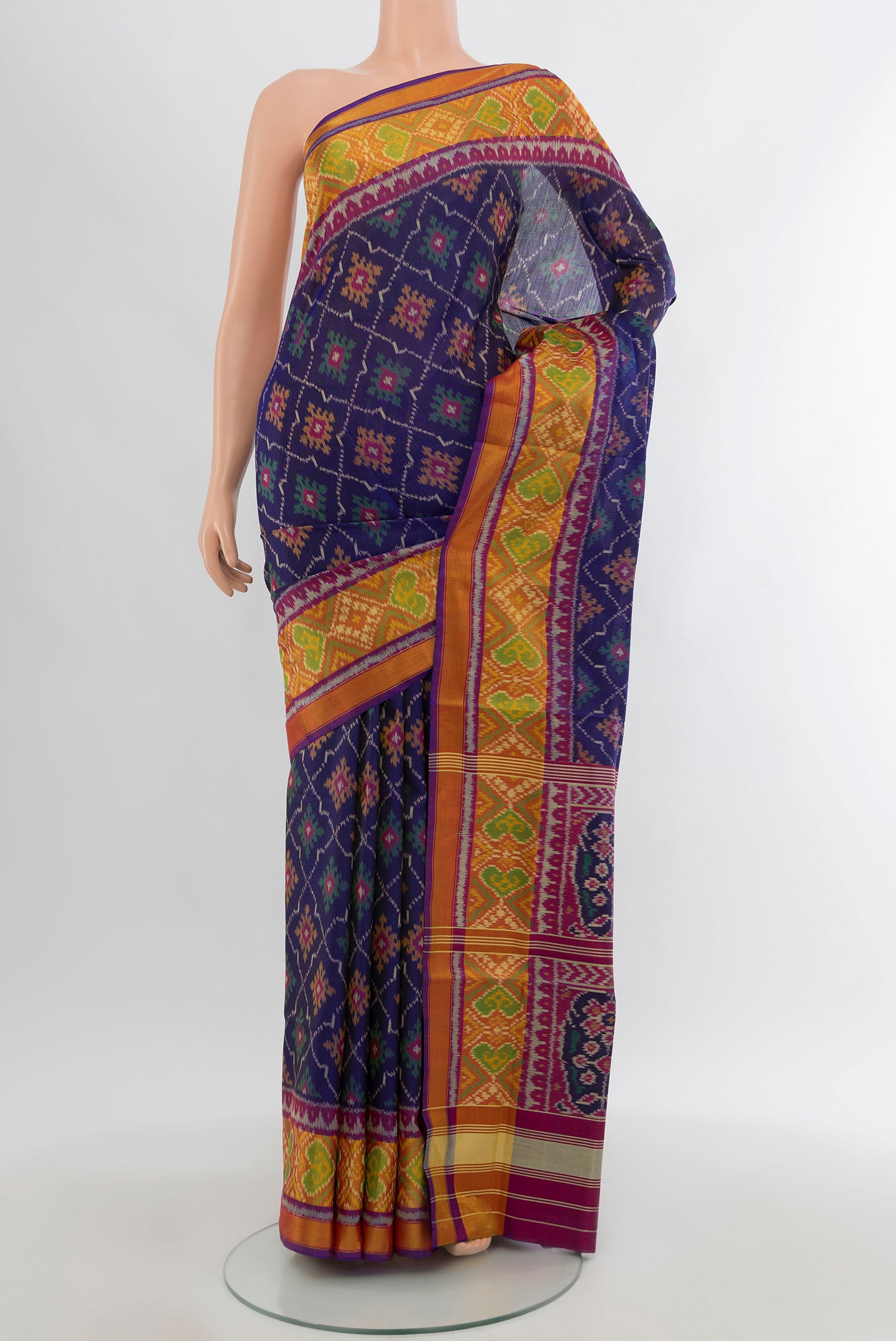 Navy Blue Rajkot Patola Silk Saree with Pure Ikat on the body and Ikat Border.  displayed on a mannequin